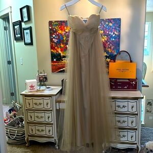 It’s a goddess netted silk underneath beautiful big on top wedding ! Santorini